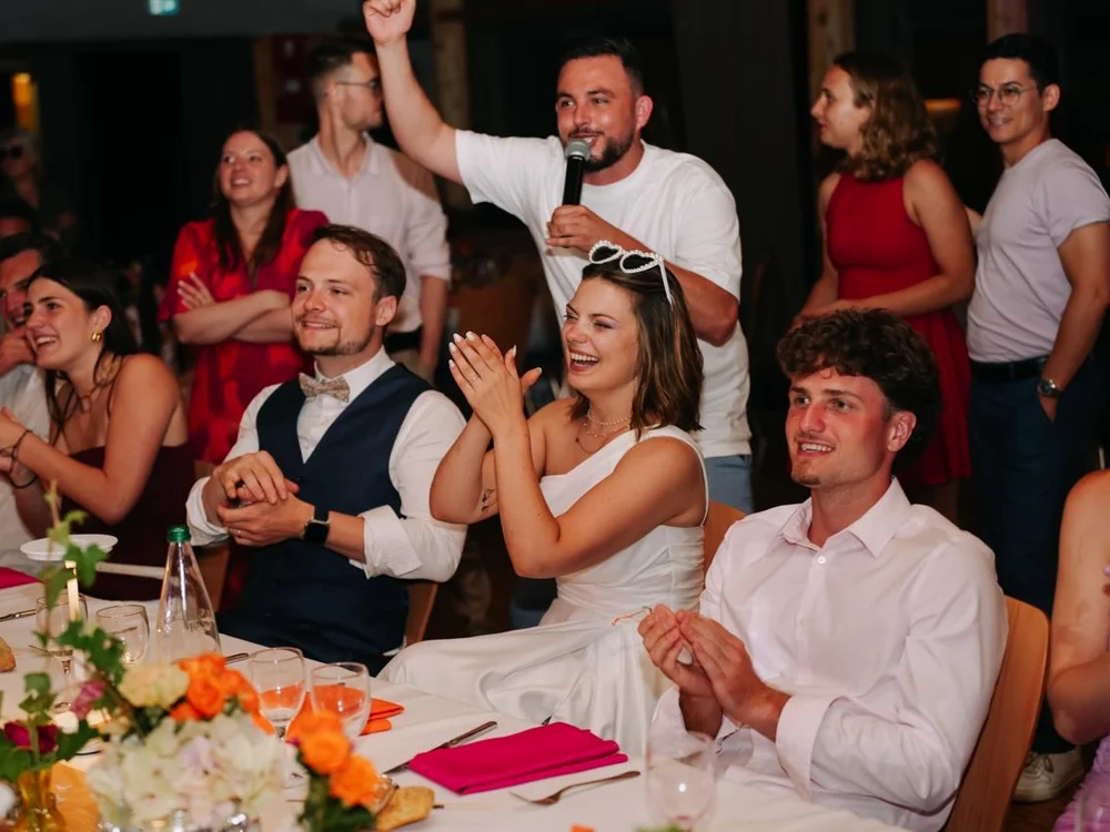 Mariés et invités qui applaudissent pendant la soirée